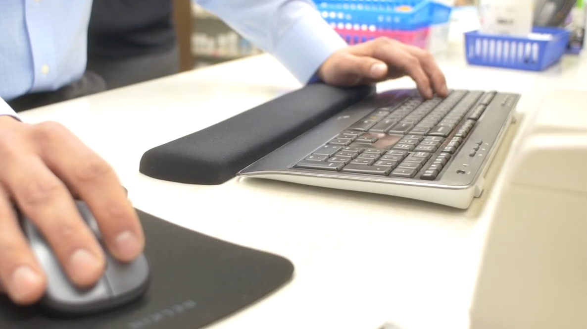 Person using keyboard and computer mouse